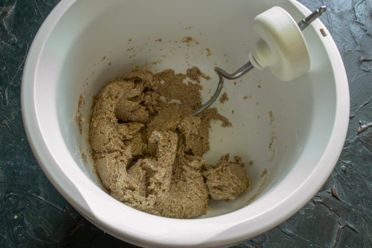 Kneading rye dough Thick and sticky rye dough gathered in a mixing bowl
