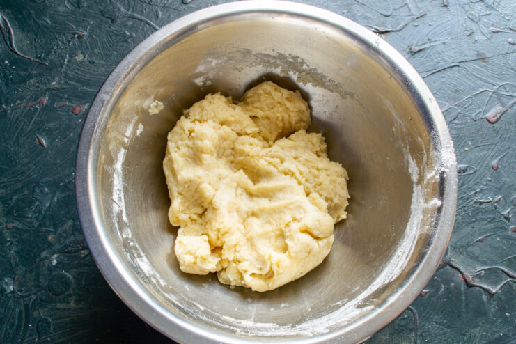 The kneaded dough resting A ball of pie dough resting in a bowl