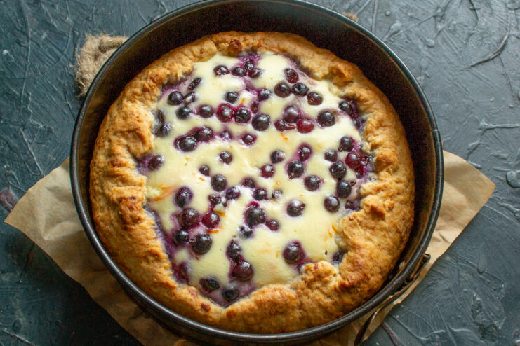 Baked golden galette resting inside a springform pan