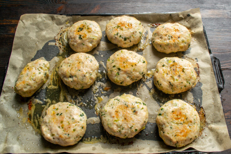 Baked patties Golden baked chicken and cilantro patties on a baking tray
