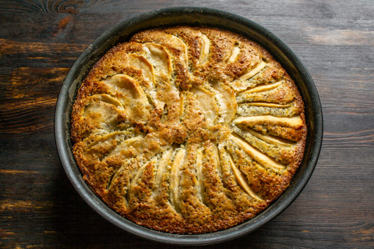 Baking until golden brown Golden brown baked apple cake sitting in a baking dish