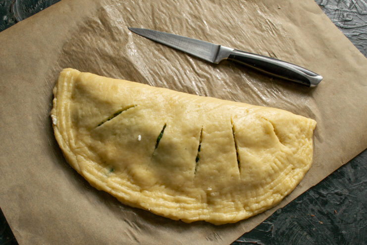 Prep For Baking Crimping the edges of a pie with a fork and cutting slits with a knife