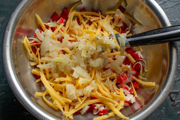 Adding Sautéed Onions Sautéed onions being added to the salad bowl