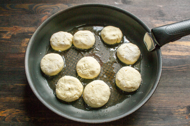 Frying the syrniki in a skillet Frying syrniki in hot oil in a skillet