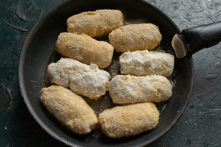 Frying the Telnoe Frying breaded fish patties in a hot skillet