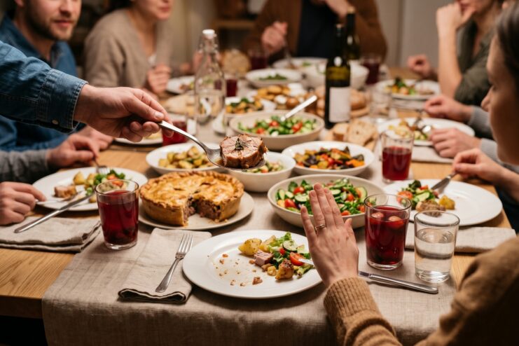 Polite Refusal of a Second Helping As a Guest Hand gesture politely refusing a second helping of meat at a festive table.