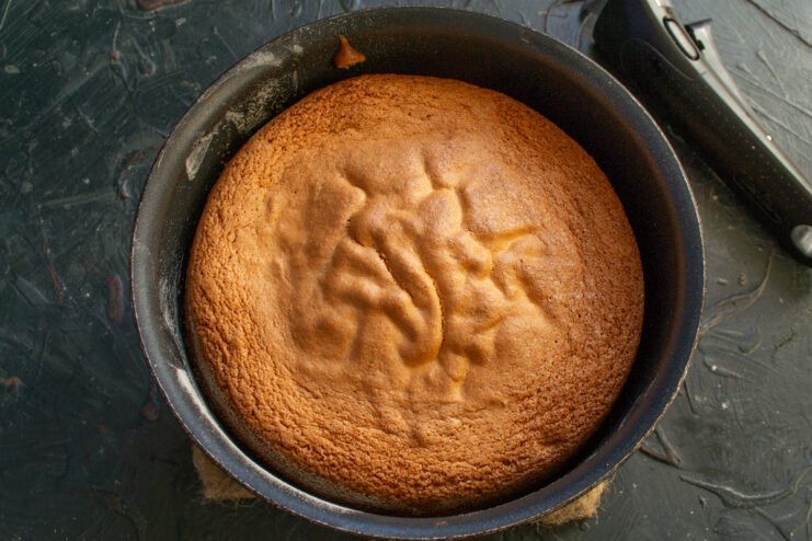 Freshly Baked Sponge Cake Golden brown baked sponge cake in a round pan