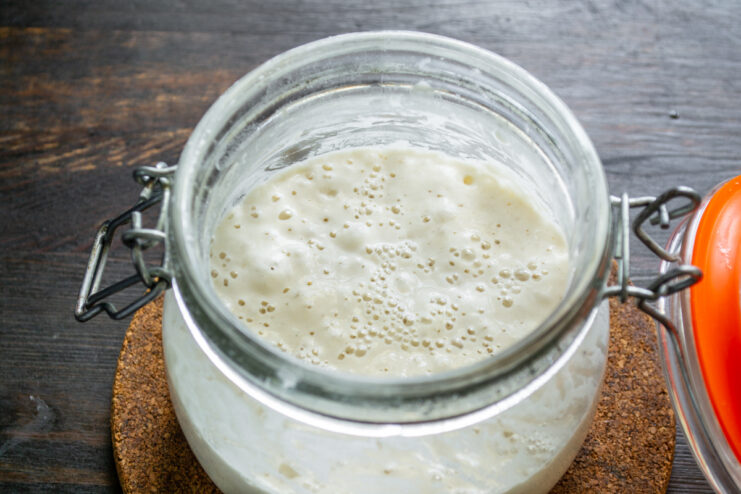 Bubbly and active sourdough starter in a glass jar
