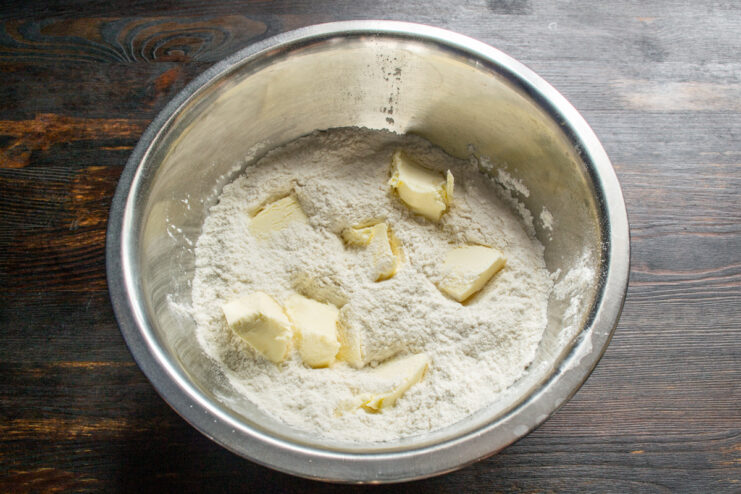 Adding cold butter cubes to the dry flour mixture