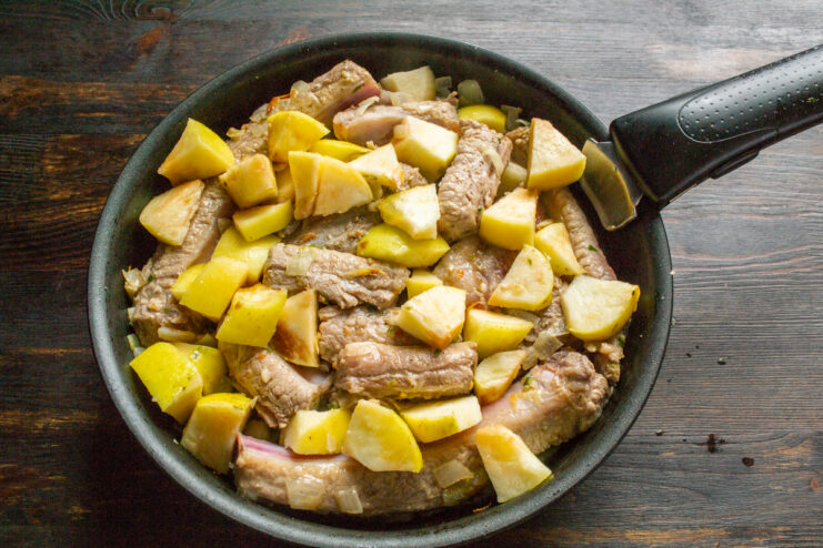 Combining the Ingredients Adding diced apples and marinade to seared ribs in a skillet