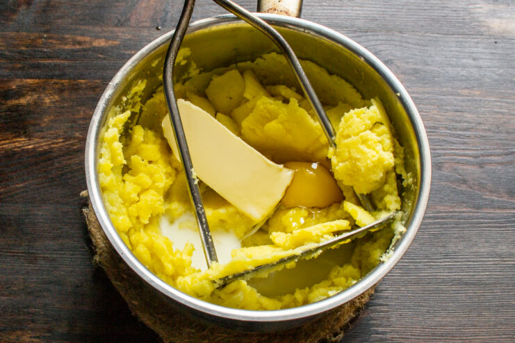 Creamy Mash Adding butter, egg, and cream to mashed potatoes