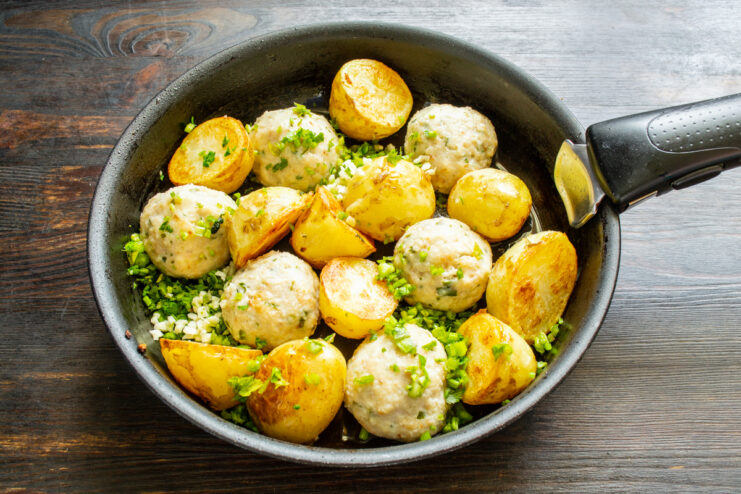 Adding chopped fresh parsley and minced garlic into a pan