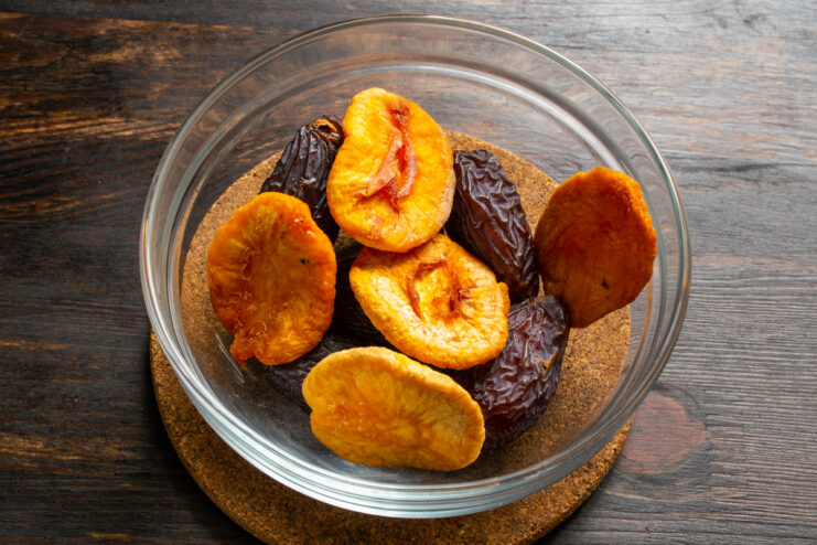 Adding dried apricots Dates and dried apricots in a bowl