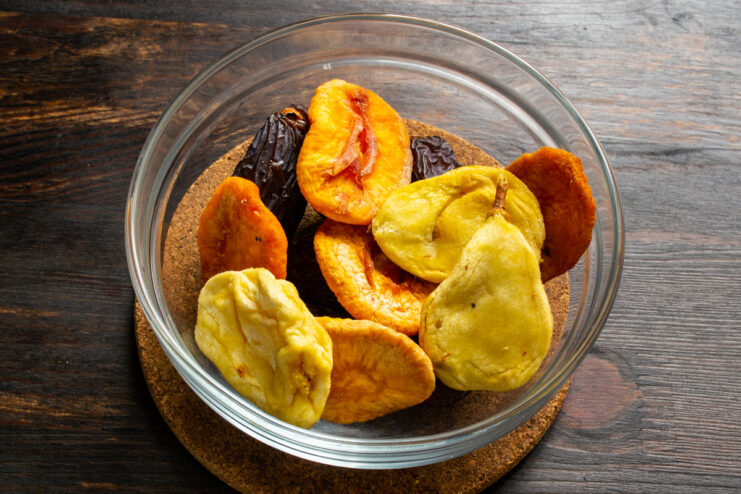 Adding dried figs Dates, dried apricots, and dried figs in a bowl