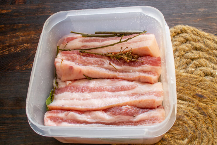 Curing pork belly resting in its own naturally extracted liquid brine