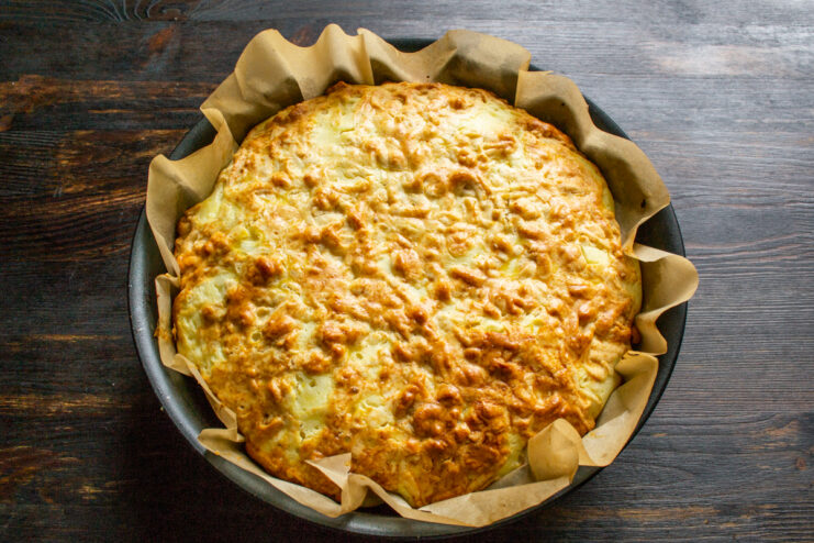 Freshly baked golden brown pie in a baking pan