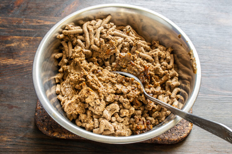 Grinding the cooked liver mixture Ground chicken liver mixture piled in a bowl