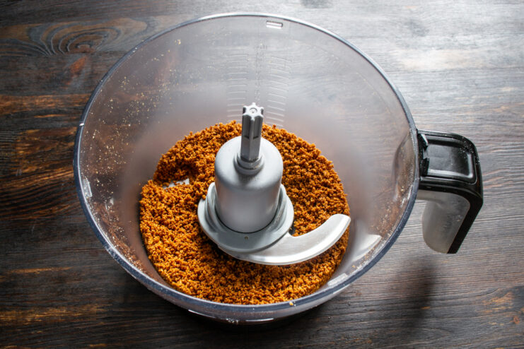 Grinding the roasted peanuts Roasted peanuts ground into fine crumbs inside a blender