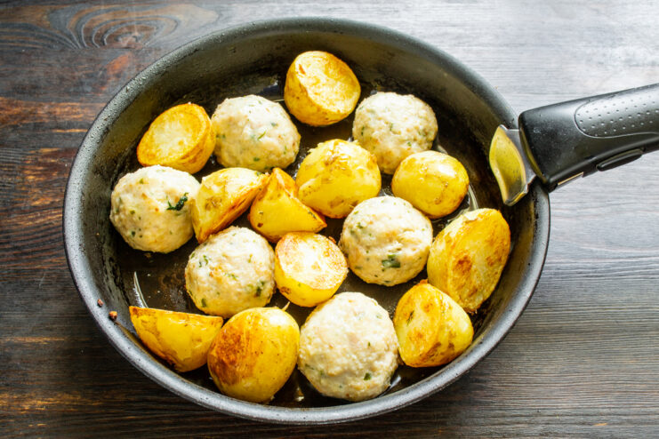 Cooking roasted potatoes and chicken meatballs together in a pan