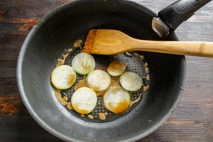 Sautéing the onions Sliced onion rings being sautéed in a hot skillet