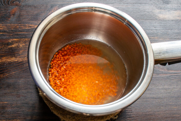 Prepping Lentils Red lentils simmering in a pot of water