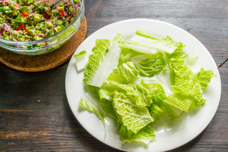 Preparing the Cabbage Base Roughly chopped Napa cabbage leaves on a white serving plate