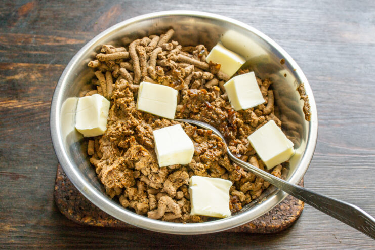 Adding butter to warm ground liver Cubes of butter added to warm ground chicken liver