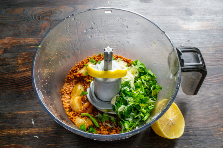Adding lemon for balance Fresh lemon juice and pulp being added to the sauce mixture