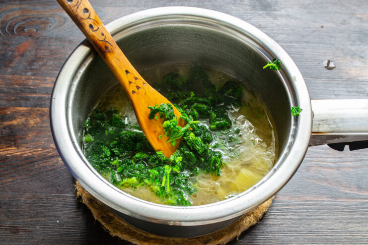 Adding nettles Finely chopped nettles simmering in a pot of soup