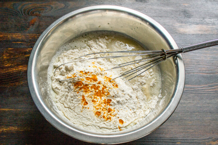 Turmeric For A Golden Hue Ground turmeric sprinkled over flour in the crepe batter bowl