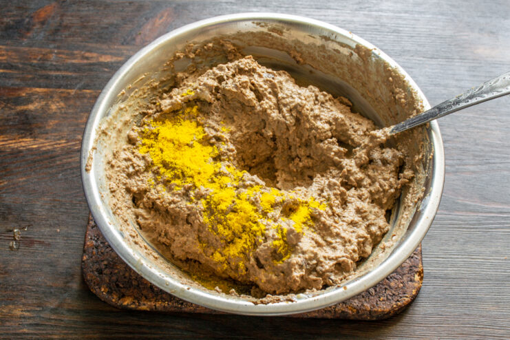 Seasoning the pâté with turmeric Ground turmeric sprinkled over chicken liver pâté in a bowl
