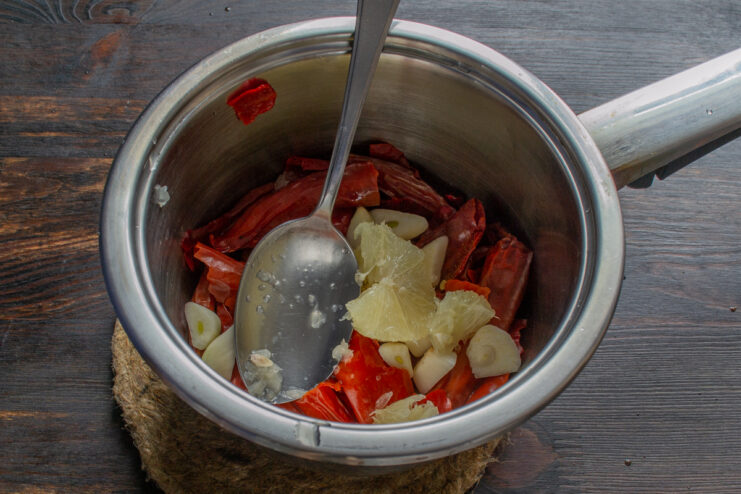 Adding lemon flesh Peeled lemon flesh added to the chilies and garlic for citrus balance