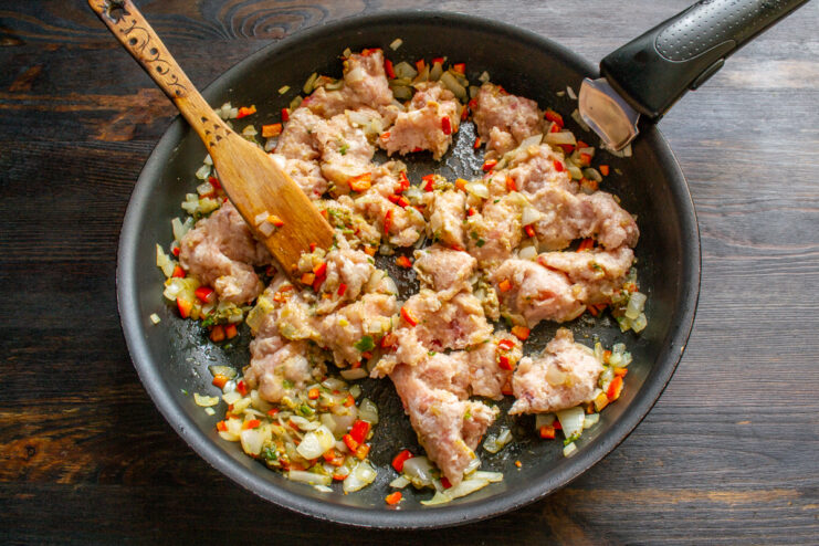 Browning The Meat Ground meat cooking with vegetables in a hot skillet