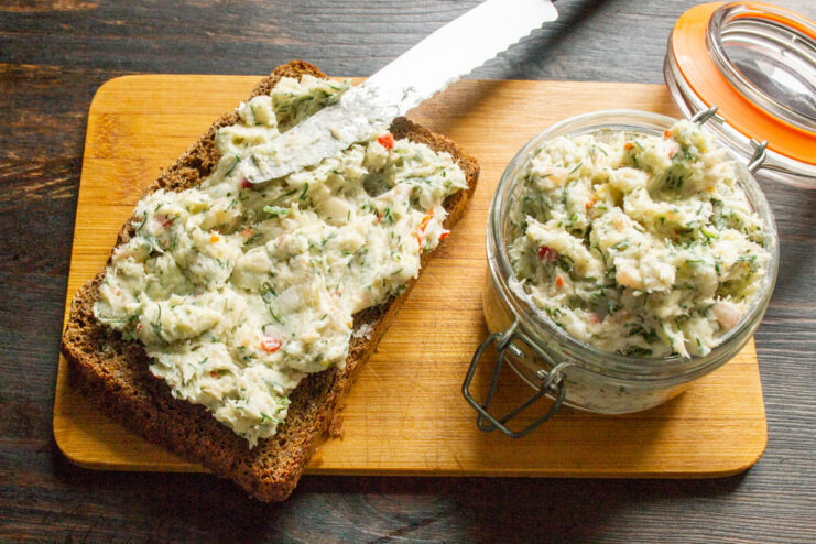 Salo spread served on bread alongside a glass jar filled with the spread