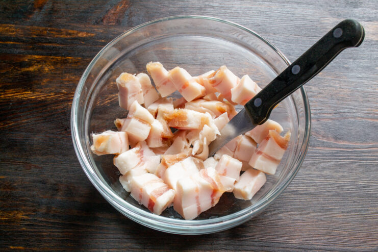 Diced cured pork fat in a clear glass mixing bowl