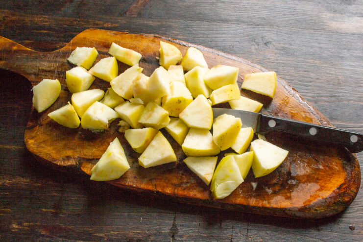 Prepping the Apples Diced apples spread out on a wooden cutting board
