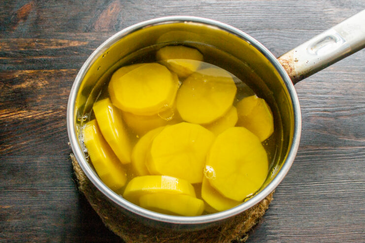 Boiling Potatoes Sliced potatoes in water for boiling