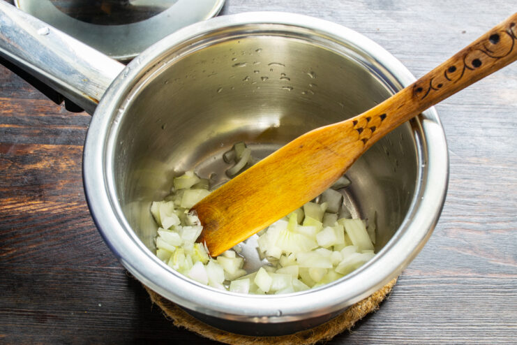 Sautéing onions Diced onions being sautéed in a pot with vegetable oil