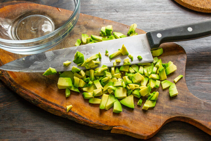 Dicing the Avocado Dicing avocado flesh into small cubes on a cutting board