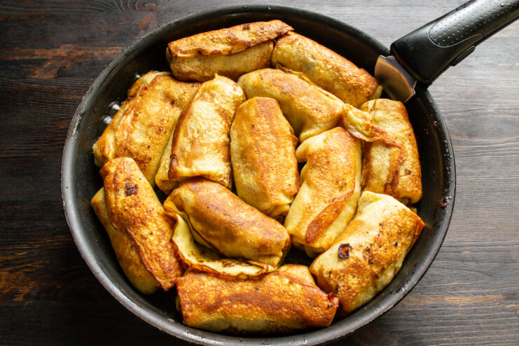 Final Pan-Frying Pan-frying folded stuffed crepes in butter in a skillet