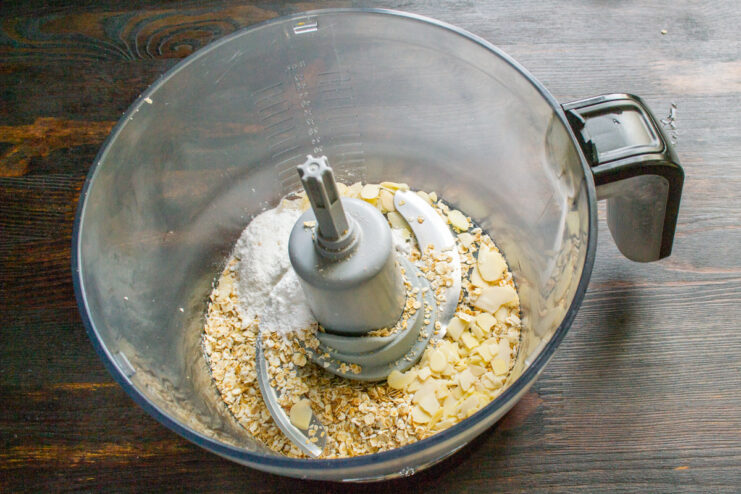 Blending the coating ingredients Rolled oats, powdered sugar, and sliced almonds in a blender bowl