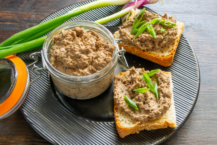 Storing and serving the chilled pâté Pâté in a glass jar served on bread slices on a dark plate
