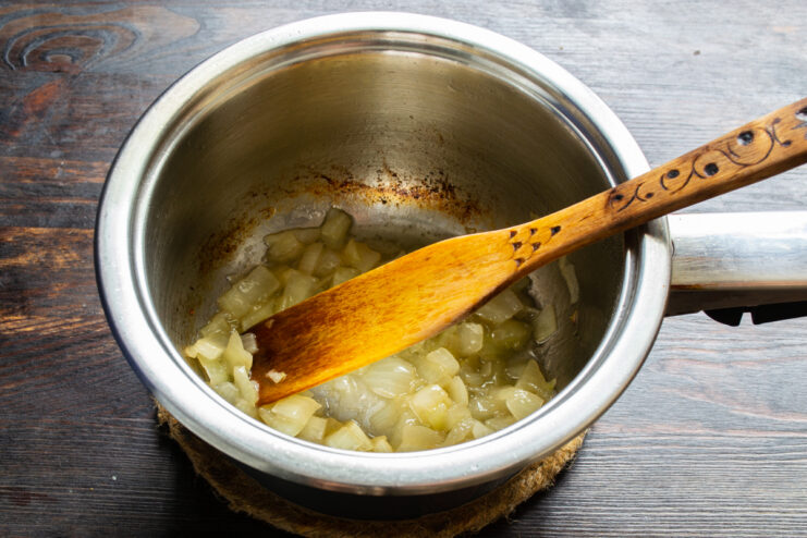 Simmering onions Sautéed onions simmering with a splash of broth in a pot