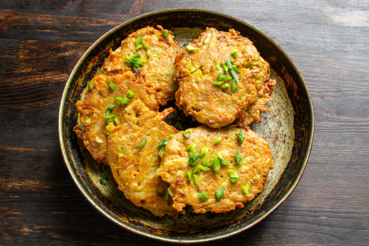 Leek fritters garnished with green onions and sour cream
