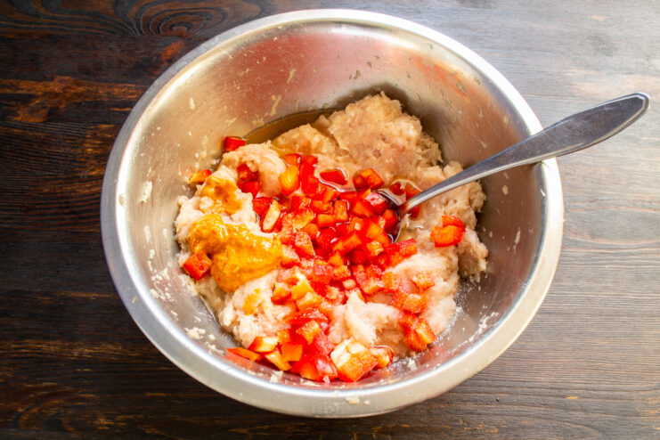 Spices and mustard for flavor Process of adding mustard and various spices to the ground meat