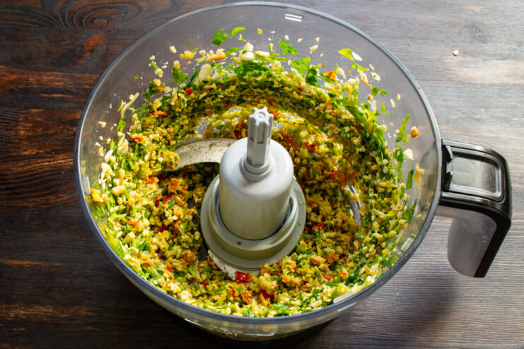 Pulsing the ingredients into a thick paste Blending all the adjika ingredients together into a smooth, uniform paste.