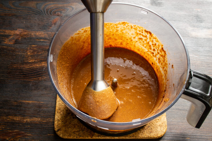 Blending the chocolate peanut paste with an immersion blender until smooth.