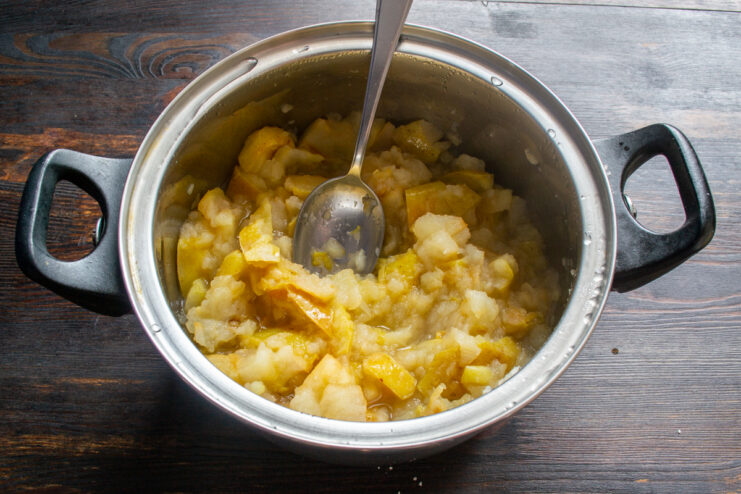 Simmering the apples Soft, fully cooked apple chunks simmering in a pot.
