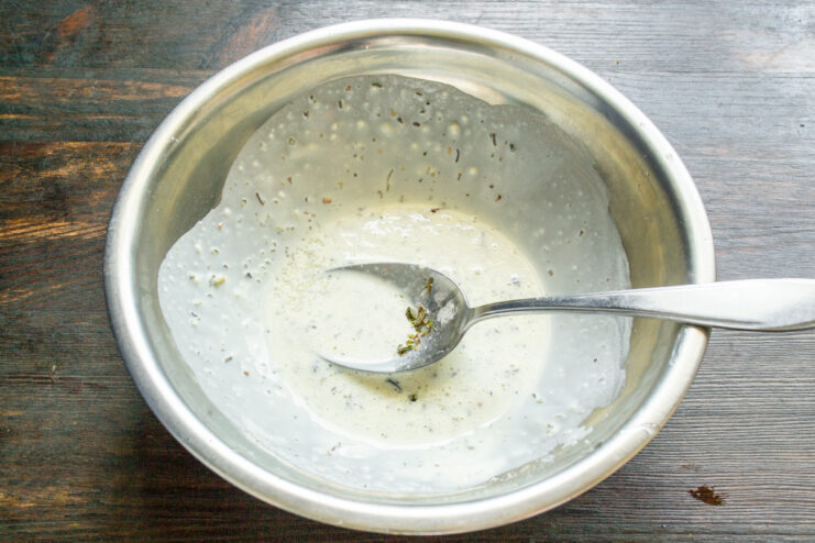 Whisking water into dry sauce ingredients in a small bowl