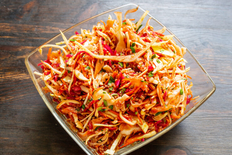 Fresh cabbage and quinoa salad beautifully arranged in a serving bowl.